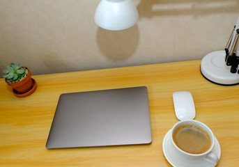 workplace. Wooden desk with laptop and coffee cup. designer working place