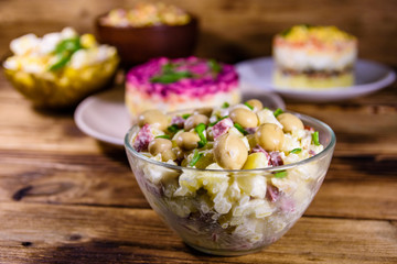 Set of festive mayonnaise salads on wooden table