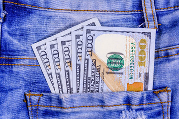 American one hundred dollar banknotes in a pocket of blue jeans
