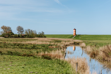 Fototapeta premium The famous Pilsum Lighthouse around Krummhoern in East Frisia, Germany