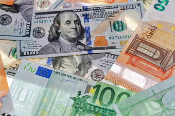 different dollar and euro bills on a white background