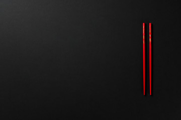 black background with red chopsticks