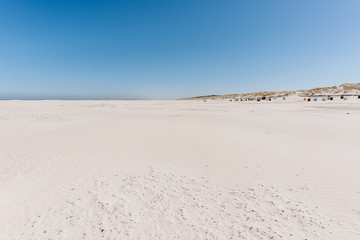 Wide sand beach landscape, sunny day, blue sky, Juist, Germany