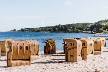 Beach chairs at the beach of the Kieler Förde, Germany, sunny day, blue sky