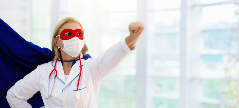 Doctor or nurse in face mask and superhero cape.