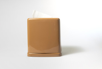 front view of toilet paper or tissue in brown rectangular napkin box on white background