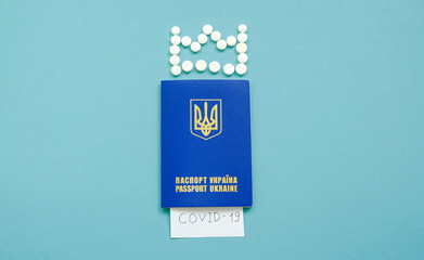 Ukrainian passport with the inscription Covid-19 and a crown of tablets