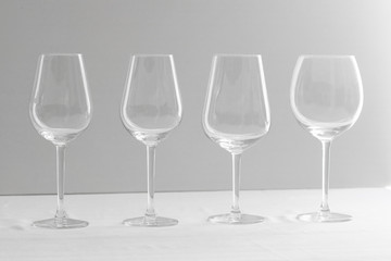  Several empty wine glasses  for red, rose, white and bordeaux  in white grey shades