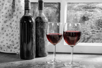 Composition with two wineglasses and bottles of red wine