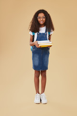 Cheerful black child with textbooks