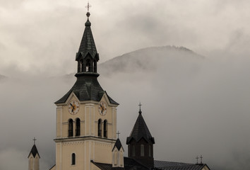 Fototapeta na wymiar Church in Bohinjska Bistrica with cloudy sky