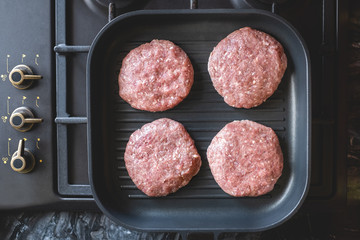 Fresh meat cutlets in a grill pan. Juicy meat steak in a pan. Cooking a burger at home. Delicious and healthy food concept.