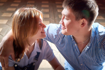 Portrait of young hipster fun couple and black background with light of flat at the night city street