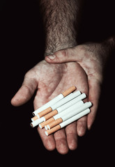 Man hold heap of cigarettes in palm