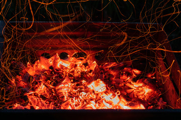 Hot coal with sparks. A barbecue in the open air.