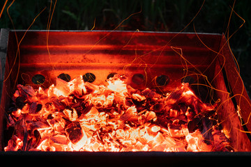 Hot coal with sparks. A barbecue in the open air.