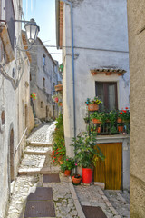 Fototapeta na wymiar A narrow street between the old houses of Castelvetere sul Calore, village in the province of Avellino, Italy