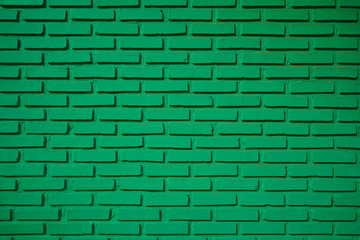 Fototapeta premium Wall painted in green for background, textures and object. Rows of brick works are built horizontally. Building, decoration, renovation ideas.