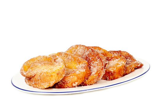 closeup of a plate with torrijas isolated on white background. Typical spanish dessert for Lent and Easter.