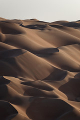 Fototapeta na wymiar Sunset wiev of abstract giant patterns in the dunes of Rub’ al Khali.