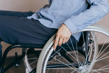 Obraz premium Unrecognizable disabled woman in wheelchair at home. Recovery and healthcare concepts.