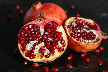 seeds of ripe pomegranate fruit close-up on a black background