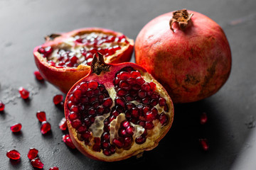 fresh ripe pomegranate fruit on a black background