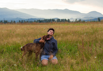woman with a dog walk on meadow