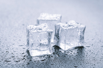 Pyramid of beautiful thawed ice cubes with drops of water