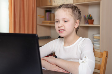 Schoolgirl does homework. Social distance, self- isolation. Home school, online education, home education, quarantine concept