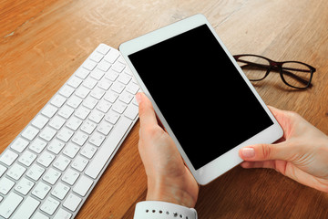 female hands holding smart phone on wooden background  , place for your text  .