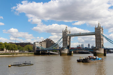 Fototapeta premium Tower Bridge with the blue sky and clouds on a bright sunny day in spring, London, UK