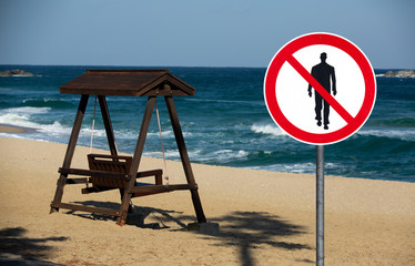  Beach with prohibition sign of people walking. Quarantine self-isolation