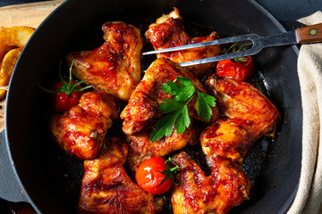 Spicy chicken wings in honey with potato wedges