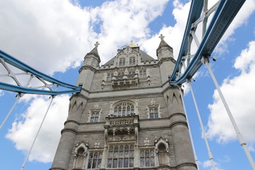 Fototapeta na wymiar Top part of Tower Bridge with the blue sky and clouds on a bright sunny day in spring, London, UK