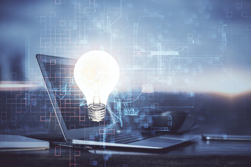 Computer on desktop in office with bulb icon hologram. Multi exposure. Concept of idea.