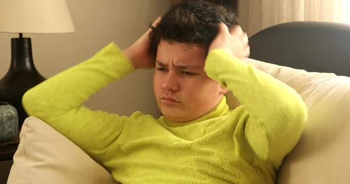 Nervous young boy itching scalp