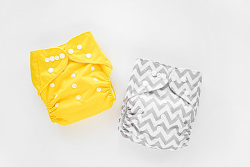 Reusable cloth baby diapers. Eco friendly cloth nappies on a white background. Sustainable...
