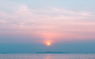 Beautiful pastel beach sunset with blue sea and golden light sky  cloud background