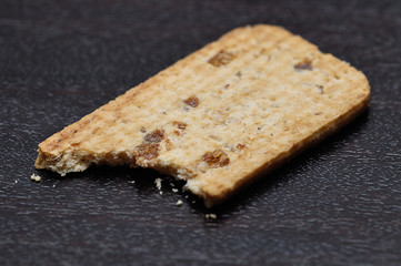 A biscuit with a bite taken from it