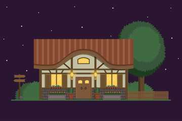 Half-timbered cottage with light in the windows and shining lanterns at night. Summer house with trees and bushes.
