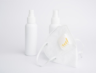 White mask-N95 for wearing germ protection  and gel alcohol or hand sanitizer spray bottle for washing hand  to protect from corona cirus set on white background