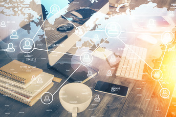 Computer on desktop with social network theme icon. Multi exposure. Concept of international connections.