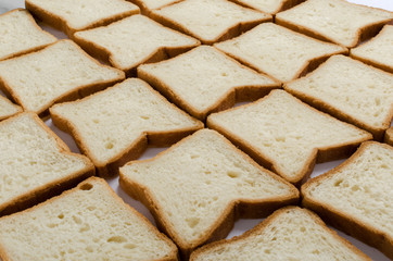 Closeup of slices of white soft bread for toasts as a background