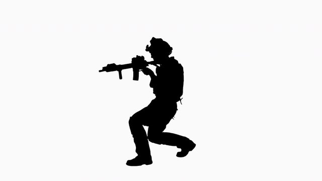 Silhouette Soldier walking aiming with rifle and using radio.