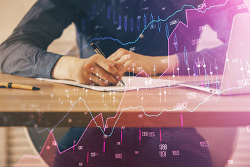 Double exposure hands with stock market chart.