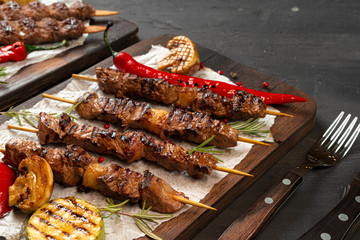 Grilled meat skewers barbecue served on board. Kebab meat