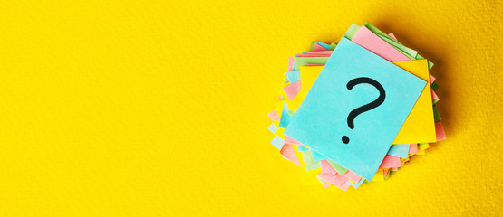 question marks written reminders tickets on yellow vintage paper background