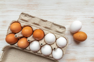 Free-range organic brown and white eggs in recycled cardboard box