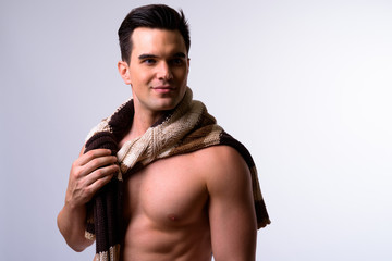 Fototapeta premium Portrait of young handsome muscular man with scarf thinking shirtless
